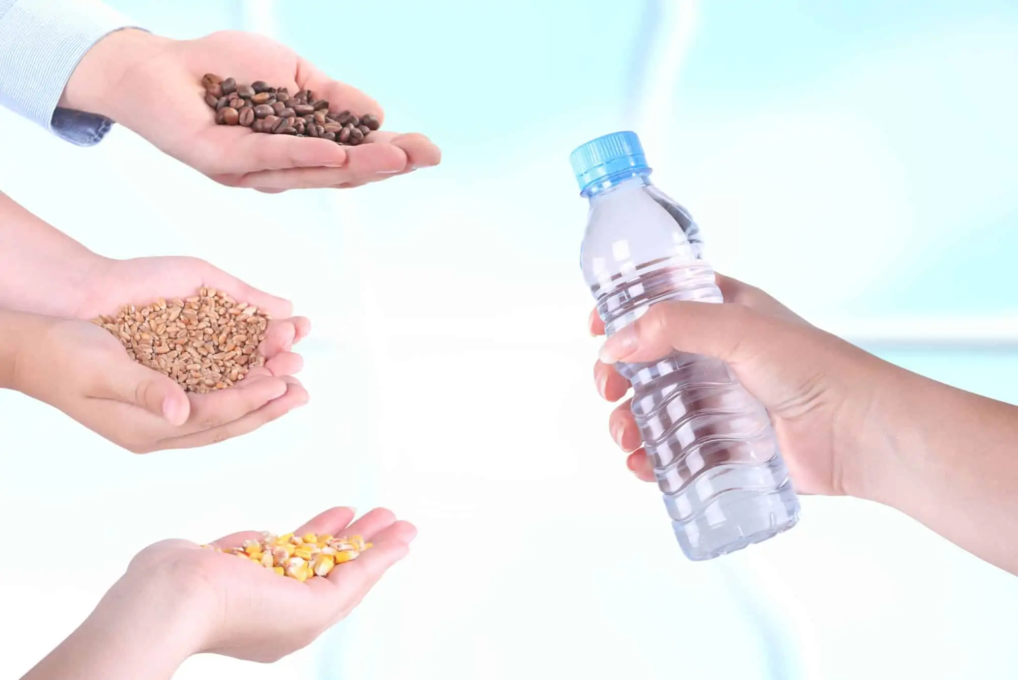 People's hands offering to barter corn, grains and coffee for bottled water in a barter network.