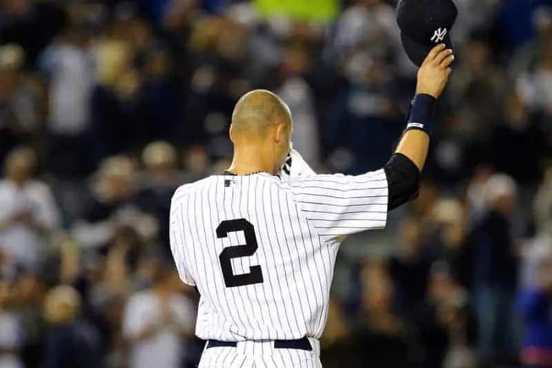 Derek Jeter standing on the field at Yankee Stadium wearing New York Yankees jersey #2 with back to camera