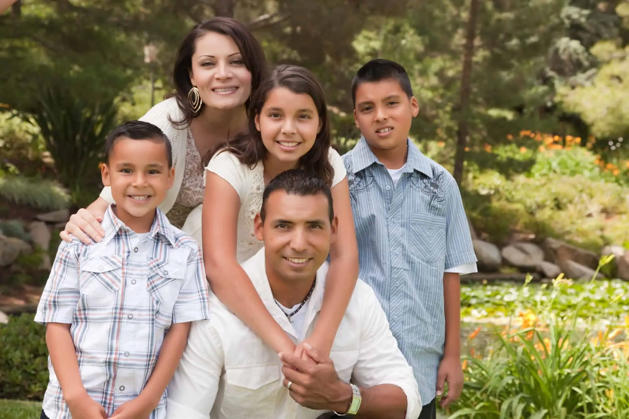 Mexican family taking a family photo in a park to celebrate the family business
